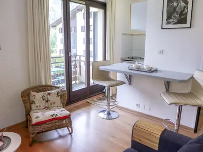 a kitchen with a table and chairs in a room at Apartment Le Cristal des Glaces by Interhome in Chamonix-Mont-Blanc