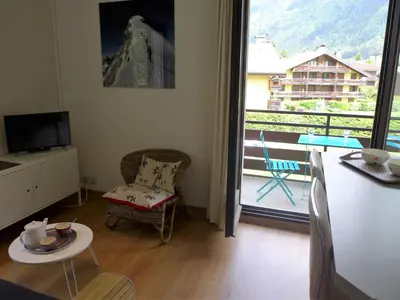 a living room with a view of a balcony at Apartment Le Cristal des Glaces by Interhome in Chamonix-Mont-Blanc