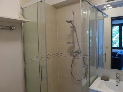 a bathroom with a glass shower and a sink at Apartment Le Cristal des Glaces by Interhome in Chamonix-Mont-Blanc