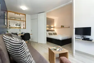 a living room with a couch and a bed at Apartment Jonquille Terrasse Centre Chamonix Mont Blanc in Chamonix-Mont-Blanc