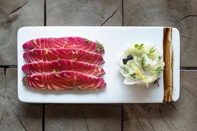 a white plate with meat and a side of salad at Hotel Le Morgane in Chamonix-Mont-Blanc