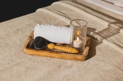 a wooden tray with a hair brush and a candle at Hôtel Les Aiglons Chamonix in Chamonix-Mont-Blanc