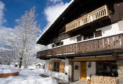 a building with snow on the ground next to it at La Grange De L'Aiguille in Chamonix-Mont-Blanc