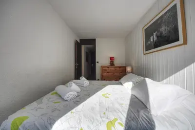 a bedroom with a bed with two pillows on it at Apartment Scott in Chamonix-Mont-Blanc