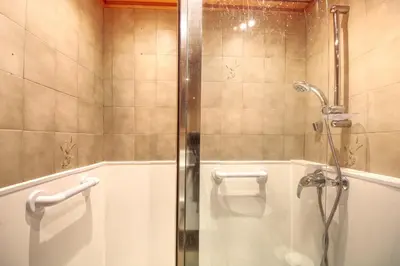 a shower with a glass door in a bathroom at Apartment Scott in Chamonix-Mont-Blanc