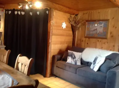 a living room with a couch in a cabin at Appartement St Nicolas in Saint-Gervais-les-Bains