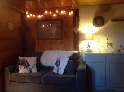 a living room with a couch with lights on it at Appartement St Nicolas in Saint-Gervais-les-Bains