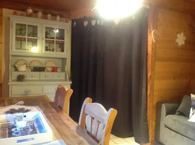 a dining room with a table and chairs and a couch at Appartement St Nicolas in Saint-Gervais-les-Bains