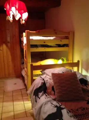 a bedroom with a bunk bed in a room at Appartement St Nicolas in Saint-Gervais-les-Bains