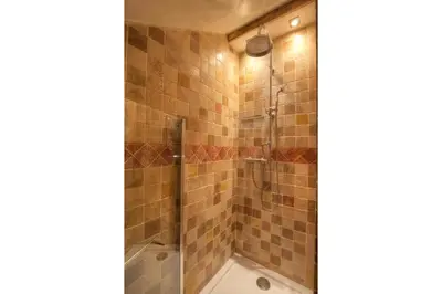 a bathroom with a shower and a tub at Chambres d'hôtes de charme Douglas in Samoëns