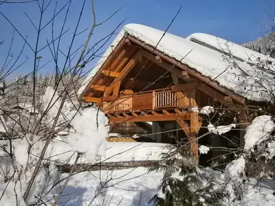 a log cabin in the snow at Chambres d'hôtes de charme Douglas in Samoëns