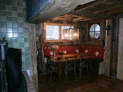 a dining room with a wooden table and chairs at Chambres d'hôtes de charme Douglas in Samoëns