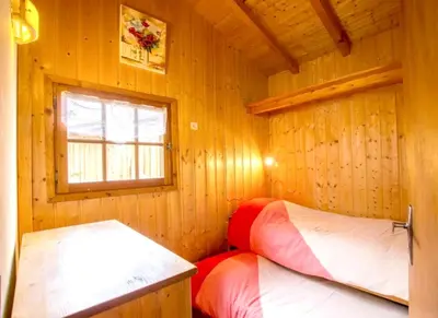 a room with two beds in a wooden cabin at Chalet confortable à Saint-Gervais-les-Bains 60 m² vue montagne in Saint-Gervais-les-Bains