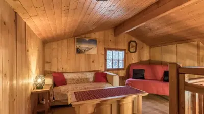 a living room with a couch and a table at Chalet confortable à Saint-Gervais-les-Bains 60 m² vue montagne in Saint-Gervais-les-Bains