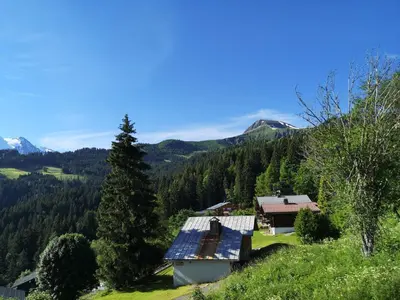 a house with solar panels on the side of a mountain at Duo Des Alpages vue exceptionnelle sur le Mont Blc in Saint-Gervais-les-Bains