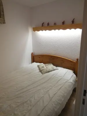 a bed with two pillows on it in a bedroom at SKI DORIS 310 Flaine Forêt in Flaine