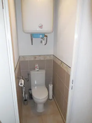 a small bathroom with a toilet and a water tank at SKI DORIS 310 Flaine Forêt in Flaine