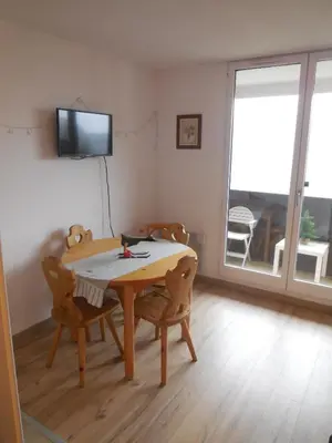 a dining room with a table and chairs and a television at SKI DORIS 310 Flaine Forêt in Flaine