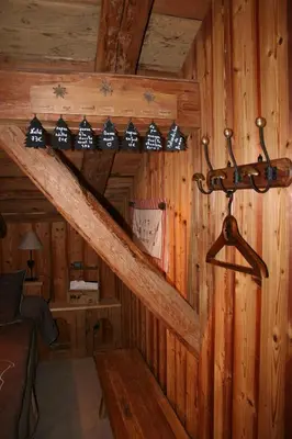 a room with a staircase in a log cabin at Chambre d'Hôtes La ferme d'en bas in Samoëns