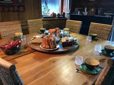a table with a turkey and other food on it at Chambre d'Hôtes La ferme d'en bas in Samoëns