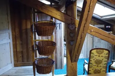 a room with wicker baskets on a wooden wall at Chambre d'Hôtes La ferme d'en bas in Samoëns