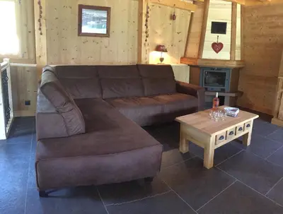 a living room with a couch and a coffee table at Chalet Lilalpes SPA in Samoëns