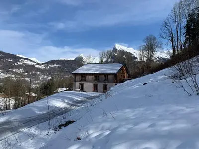 a house on a hill covered in snow at Le Chalet dans les Etoiles in Samoëns