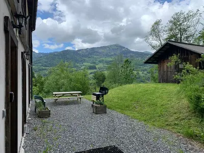 a picnic table and a bench in a field at Le Chalet dans les Etoiles in Samoëns