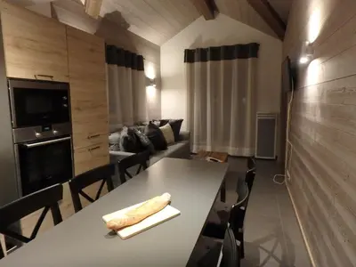 a kitchen and living room with a table and a couch at Chamonix IRIS in Chamonix-Mont-Blanc