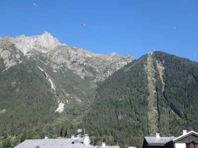 a view of a mountain range with a house at Chamonix IRIS in Chamonix-Mont-Blanc