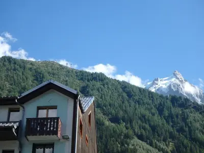 a building with a mountain in the background at Chamonix IRIS in Chamonix-Mont-Blanc
