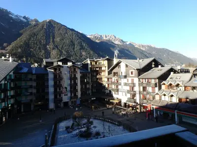 a group of buildings in front of a mountain at Chamonix IRIS in Chamonix-Mont-Blanc