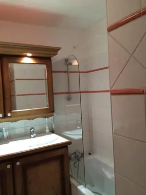 a bathroom with a sink and a shower and a tub at Facing the Chamonix Needles in Les Houches