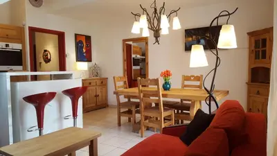 a kitchen and living room with a couch and a table at Duplex Les Périades 18 in Saint-Gervais-les-Bains