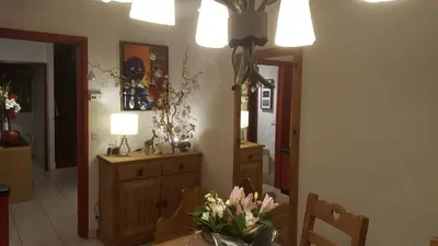 a dining room with a table with flowers on it at Duplex Les Périades 18 in Saint-Gervais-les-Bains