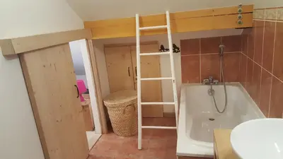 a small bathroom with a tub and a sink at Duplex Les Périades 18 in Saint-Gervais-les-Bains