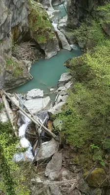 a river with a bridge in the middle of a mountain at Duplex Les Périades 18 in Saint-Gervais-les-Bains