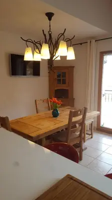 a dining room with a wooden table and chairs at Duplex Les Périades 18 in Saint-Gervais-les-Bains