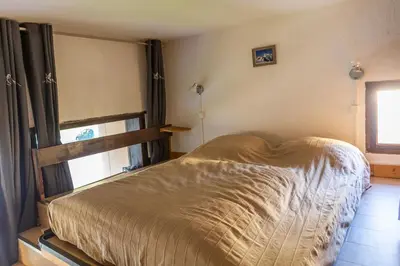 a bedroom with a bed and a window at Duplex Chamonix Les Grands Montets in Chamonix-Mont-Blanc