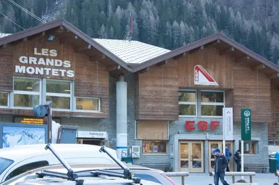 a ski lodge with a car parked in front of it at Duplex Chamonix Les Grands Montets in Chamonix-Mont-Blanc