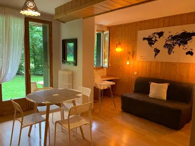 a living room with a table and a couch at Chamonix Studio Jardin in Chamonix-Mont-Blanc