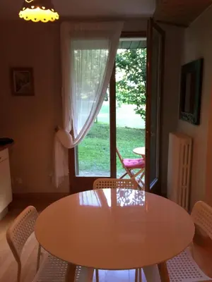 a table and chairs in a room with a window at Chamonix Studio Jardin in Chamonix-Mont-Blanc