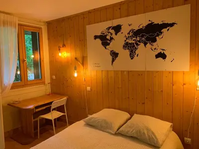 a bedroom with a wall with a map of the world at Chamonix Studio Jardin in Chamonix-Mont-Blanc
