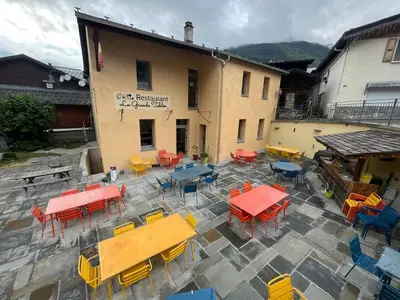 a large room with tables and chairs in it at Gite Michel Fagot in Les Houches