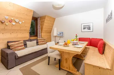 a living room with a table and a couch at Le Paradis 18 & 18b appts - Chamonix All Year in Chamonix-Mont-Blanc