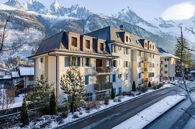 a house in the mountains with snow on the ground at Le Paradis 18 & 18b appts - Chamonix All Year in Chamonix-Mont-Blanc