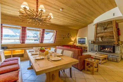 a living room with a table and a fireplace at Le Paradis 18 & 18b appts - Chamonix All Year in Chamonix-Mont-Blanc