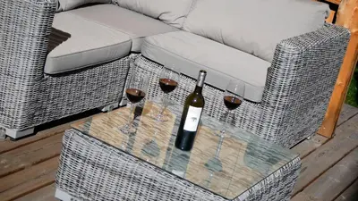 a bottle of wine and wine glasses on a table at LES 3 CIMES BLANCHES in Chamonix-Mont-Blanc