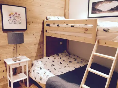 a bedroom with two bunk beds and a ladder at Grand Paradis in Chamonix-Mont-Blanc