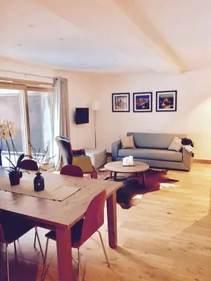 a living room with a couch and tables at Grand Paradis in Chamonix-Mont-Blanc
